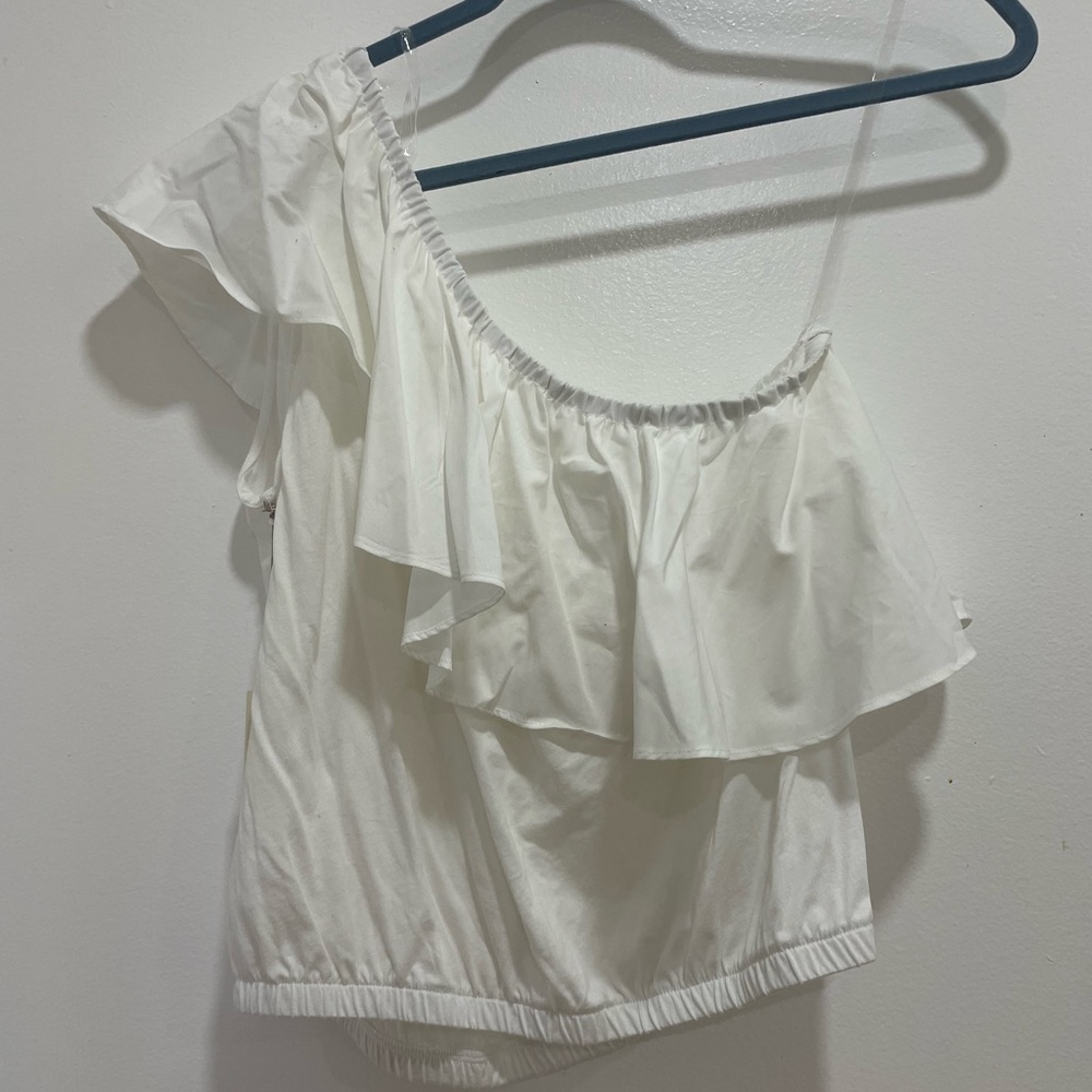 One shoulder, white top